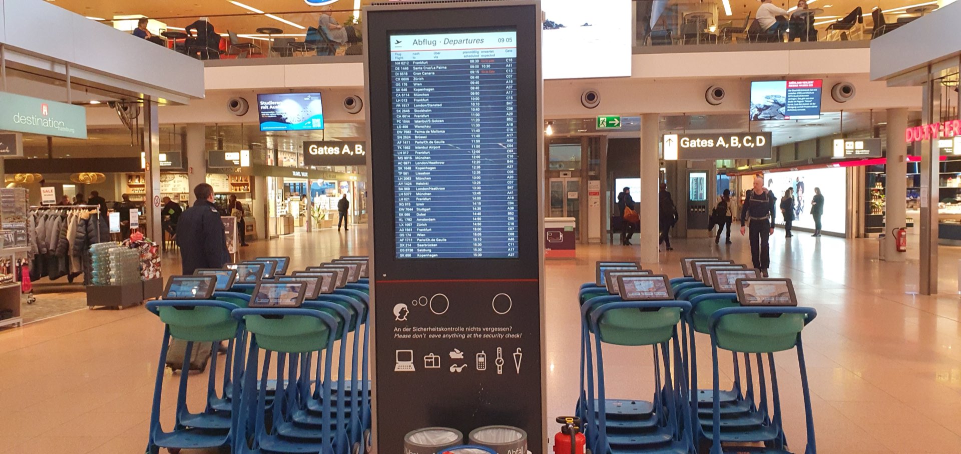 AI-TS smart airport trolleys with integrated touchscreens in an international airport terminal
